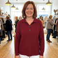 Constance polo-collar button jumper in Burgundy, worn in a boutique