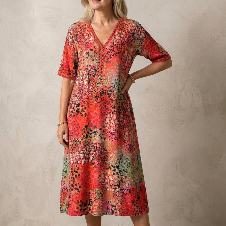 Iris flowing midi dress in Red, against a plaster wall