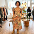 Iris flowing midi dress in Beige, worn in a boutique