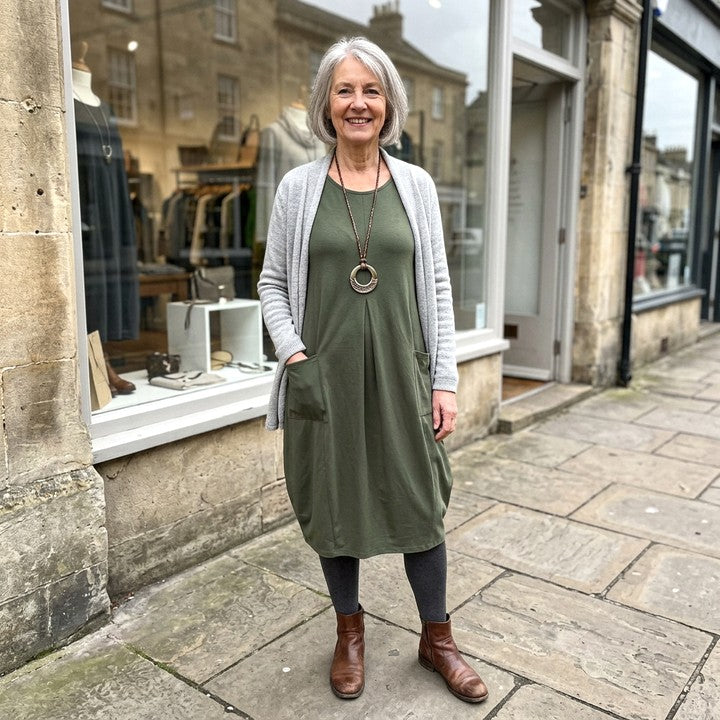Kwani flowing dress in Green, worn in front of a boutique