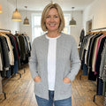 Margot zip-up cardigan in Grey, worn in a boutique